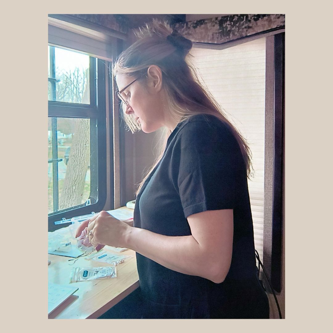 Designer and maker of fine silver jewelry at workbench