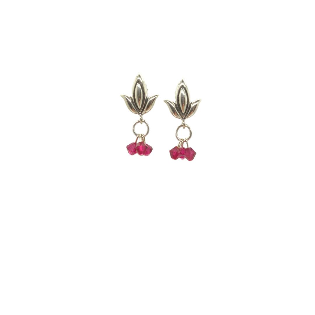 Three ruby bicones hanging on sterling silver leaf bails